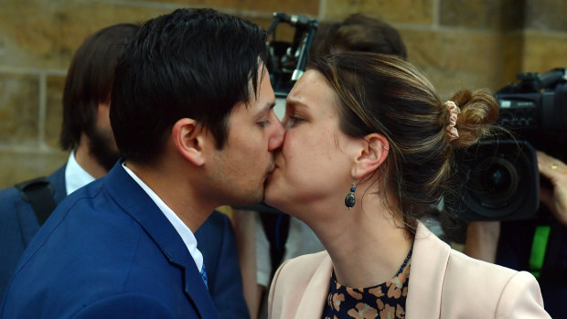 Blake Davis and Hannah Quinn kiss outside court before leaving with family.