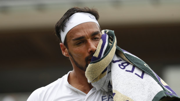 Repent at leisure: Italy's Fabio Fognini wipes his face as he plays United States' Tennys Sandgren.
