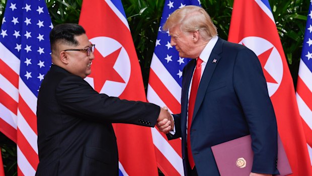 North Korean leader Kim Jong-un, left, and US President Donald Trump shake hands at the conclusion of their meetings on Sentosa Island in Singapore in June 2018.