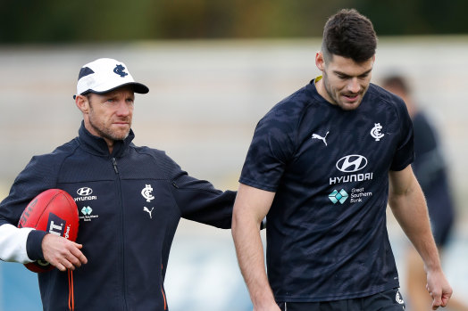 Carlton’s high-performance boss Andrew Russell with midfielder George Hewett (right).