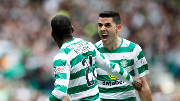 Bragging rights: Olivier Ntcham (left) celebrates with teammate Tom Rogic after scoring in Celtic's victory over Rangers.