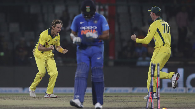 Adam Zampa (left) celebrates the wicket of India's Rohit Sharma in the final one-day international in Delhi this summer.