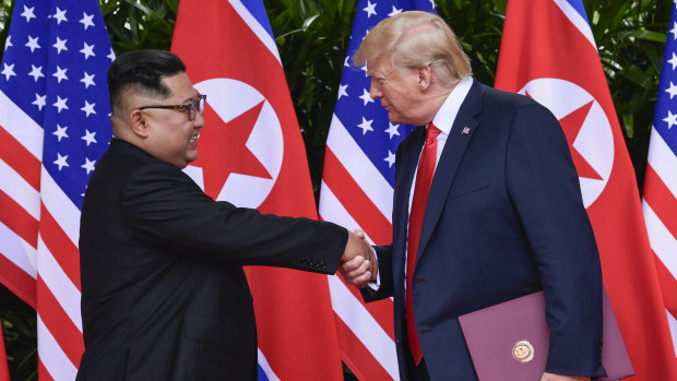 North Korea leader Kim Jong Un and US President Donald Trump shake hands, holding it for 13 seconds.