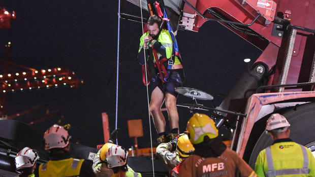 A man trapped after a crane flipped over is freed.