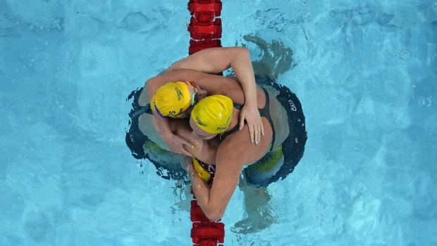 Mollie O’Callaghan and Ariarne Titmus embrace at the finish.