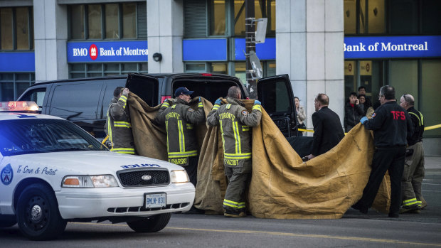 Officials carry a body into a vehicle after the incident police said "definitely looked deliberate".