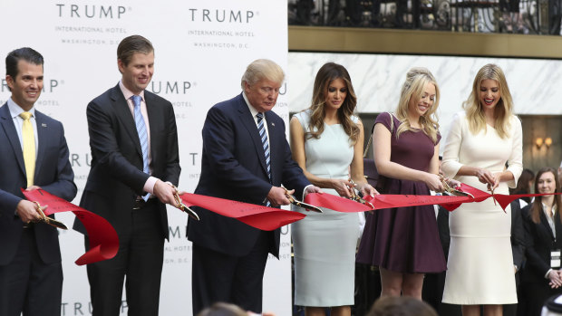 New generation: Donald Trump and family members cut the ribbon at the opening of the  Trump International Hotel in Washington in 2016. 