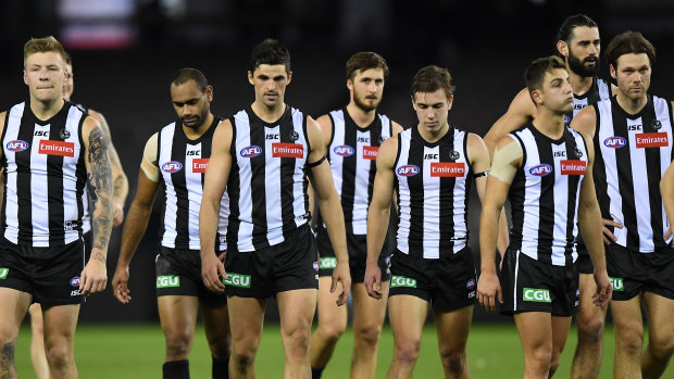 Downcast: Magpies leave the field after registering their lowest game score in 24 years.