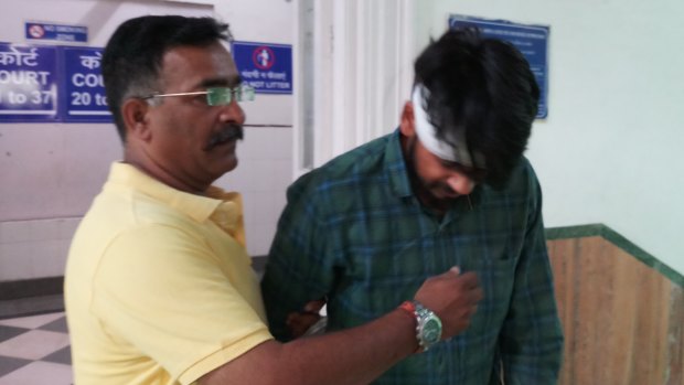 Hit-run driver Puneet Puneet (right) leaves court with his uncle in Dehli on Friday.