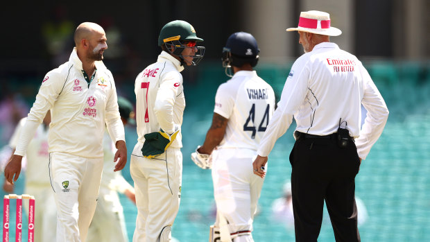 Tim Paine confronts umpire Paul Wilson on day three at the SCG. 