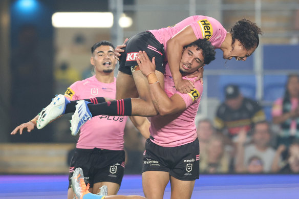 Jarome Luai is lifted by Izack Tago after a Penrith try.