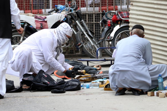 Pakistani security officials inspect weapons and ammunition recovered at the scene of the attack.