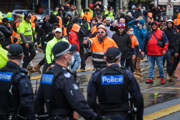 Police and protesters face off at the front of the CFMEU office on Elizabeth Street last week.