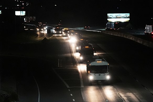 A convoy of buses moves along Interstate Highway 10 after leaving the Marine Corps base in Twentynine Palms, California.