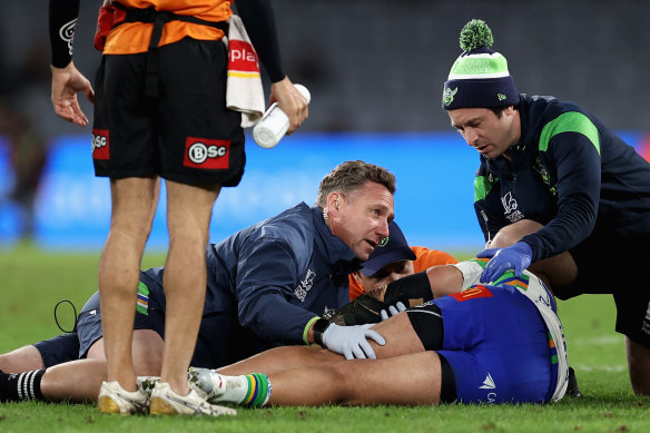 Raiders forward Corey Harawira-Naera receives attention after collapsing on the field.