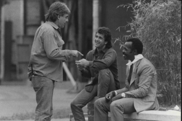 Mel Gibson and Danny Glover with director Richard Donner in 1987.