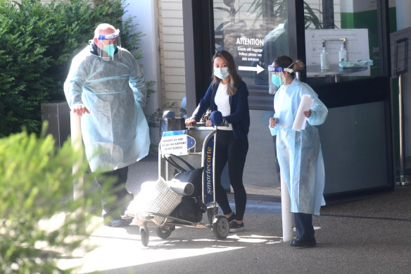 A guest is evacuated from the Holiday Inn quarantine hotel on Wednesday morning. 