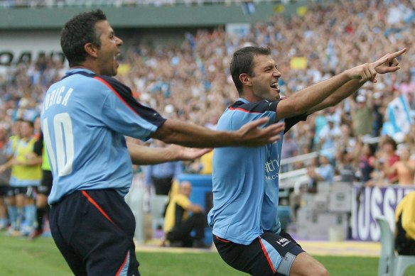 Steve Corica and Mark Rudan celebrate a goal together during their days as teammates at Sydney FC.