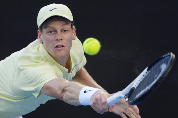 Jannik Sinner of Italy scrambles for a return.