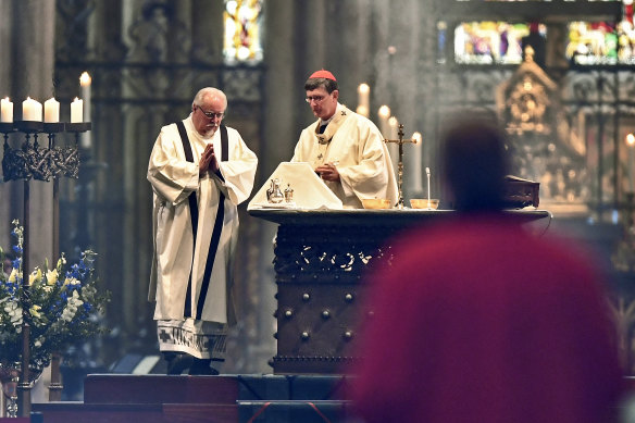German Cardinal and Archbishop Rainer Woelki, right, celebrate the first church service at Germany's most famous Cologne Cathedral since the ban due of the coronavirus pandemic.