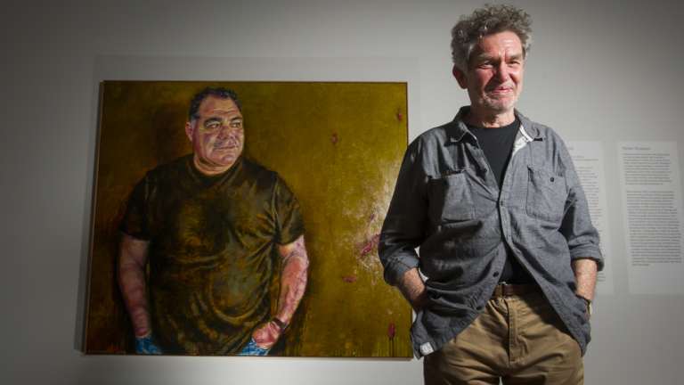 Artist Peter Hudson and his portrait of Mal Meninga. 