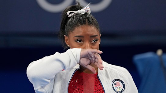Simone Biles watches after exiting the team final.