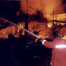 Firemen attempt to extinguish the blaze ignited by a bomb blast at the Sari night club on the island of Bali in 2002.
