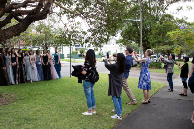 Parents and siblings look on as students from Strathfield Girls High School head to their school formal.