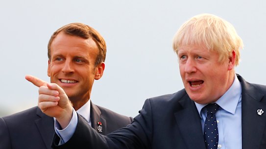 French President Emmanuel Macron, left, welcomes Britain's Prime Minister Boris Johnson at the Biarritz lighthouse, southwestern France, at G7.