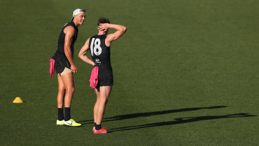 Patrick Cripps has a word with Sam Walsh.