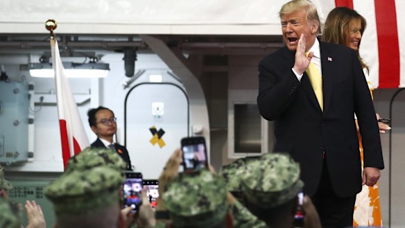 President Donald Trump and first lady Melania Trump visit a US naval base in Japan on Tuesday.