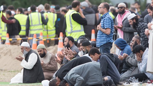 Mourners pray as funerals continue. 