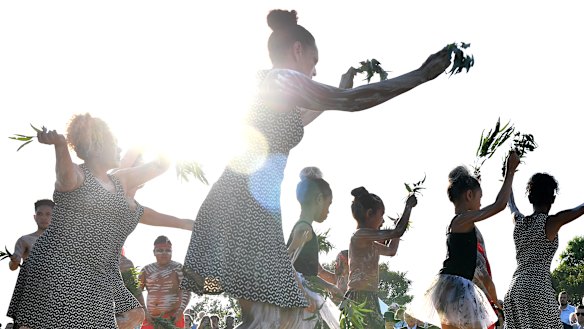 Koomurri dancers perform during the Arrival of Fire at the Australia Day Wugulora Morning Ceremony on the Walumil Lawns at Barangaroo in Sydney.