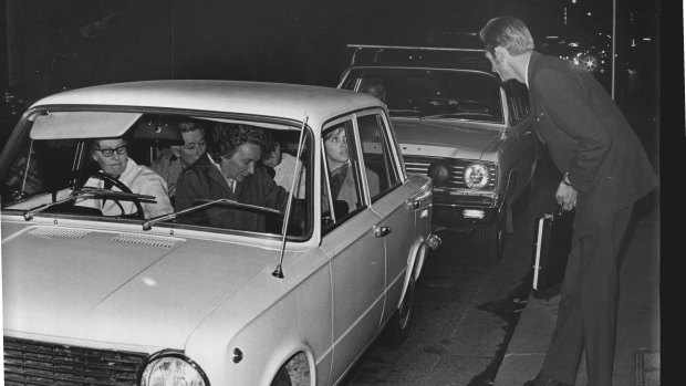 A lucky hitchhiker scores a lift in an already crowded car on Clarence Street, Sydney. May 21, 1969.