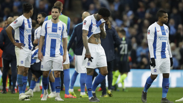 Disappointed Brighton players after their loss.