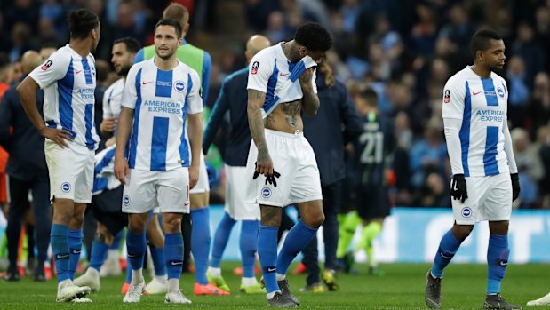 Disappointed Brighton players after their loss.