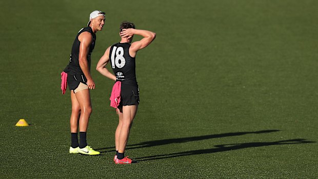 Patrick Cripps has a word with Sam Walsh.