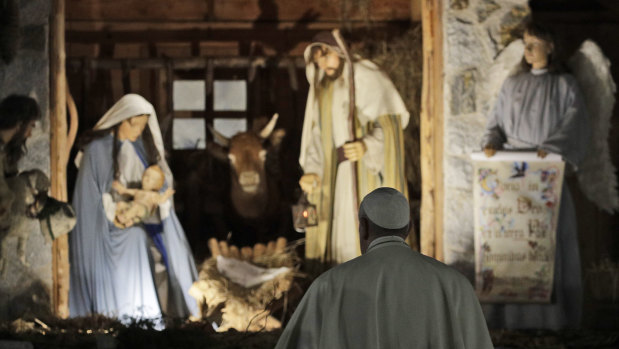 Pope Francis stops to view the Nativity scene in St Peter's Square.