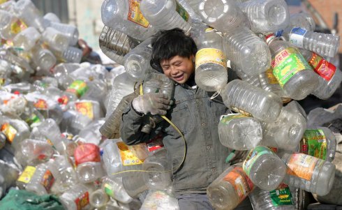 A Chinese waste worker shifts through waste in a practice soon to decline as overseas waste exports stop from next year.