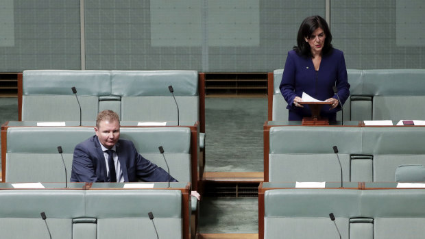 Liberal MP Craig Laundy listening as Julia Banks announces her decision to quit the party.