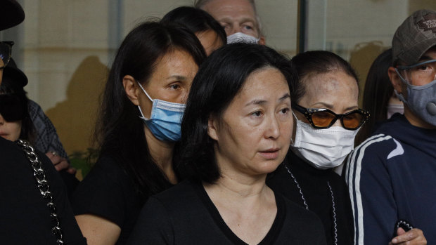 Stanley Ho's daughter, Pansy (centre), speaks alongside other family members outside a hospital in Hong Kong on Tuesday.