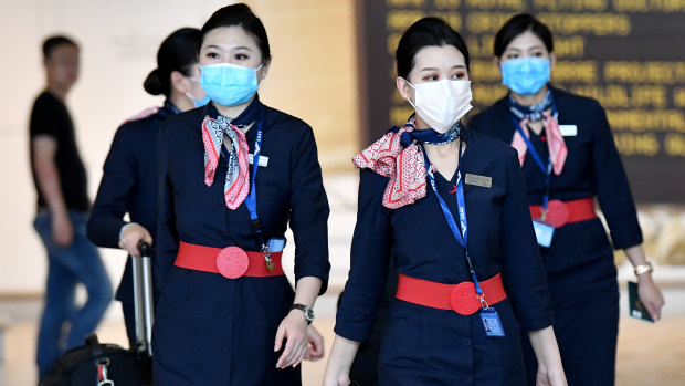 China Eastern Airlines cabin crew wear face masks at Brisbane International Airport last week.