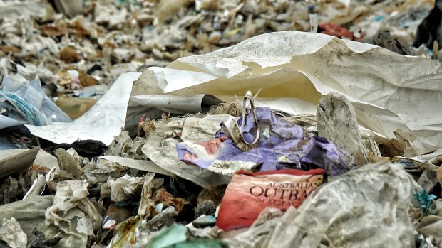 An Australian-branded baby wipes wrapper and a drink cover from Australia are found among the piles of imported plastic wastes at a closed down illegal plastic recycling factory in Jenjarom.