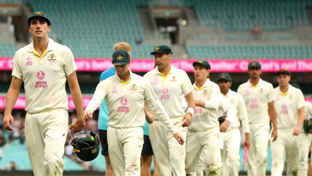 Cummins walks his team off the SCG after coming so close to victory. 