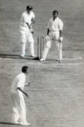 Joe Solomon out after his cap had dislodged the bails.   Wicket keeper Wally Grout, Richie Benaud foreground looking at square-leg umpire.