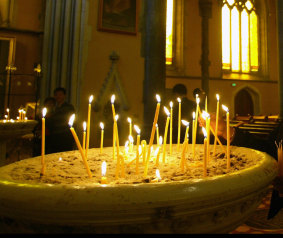 The lighting of candles in worship.