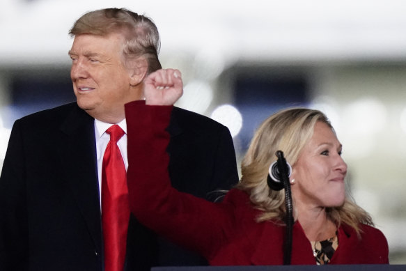 Republican midterms victor Marjorie Taylor Greene at a rally with then president Donald Trump on January 4 last year.