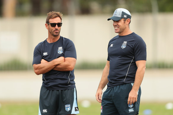 Andrew Johns and Brad Fittler run their eyes over a Blues training session in 2019.