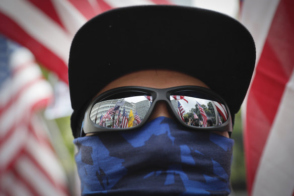 US flags are reflected in a protester's glasses during Sunday's march.
