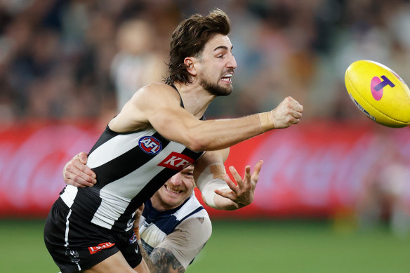 Josh Daicos fires off a handball.